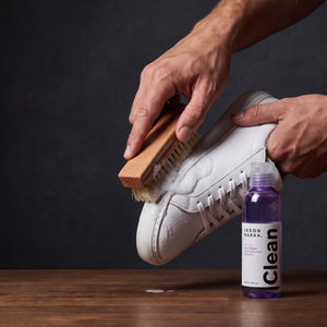 Jason Markk Essential Kit - hands cleaning a sneaker with brush