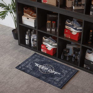 a shoe rack with shoes and a rug on the floor